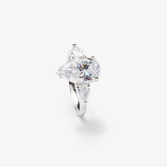 Pear cut three-stone engagement ring by IRALIS featuring lab-grown diamonds in DEF color and VS1–VS2 clarity, Zurich designed
