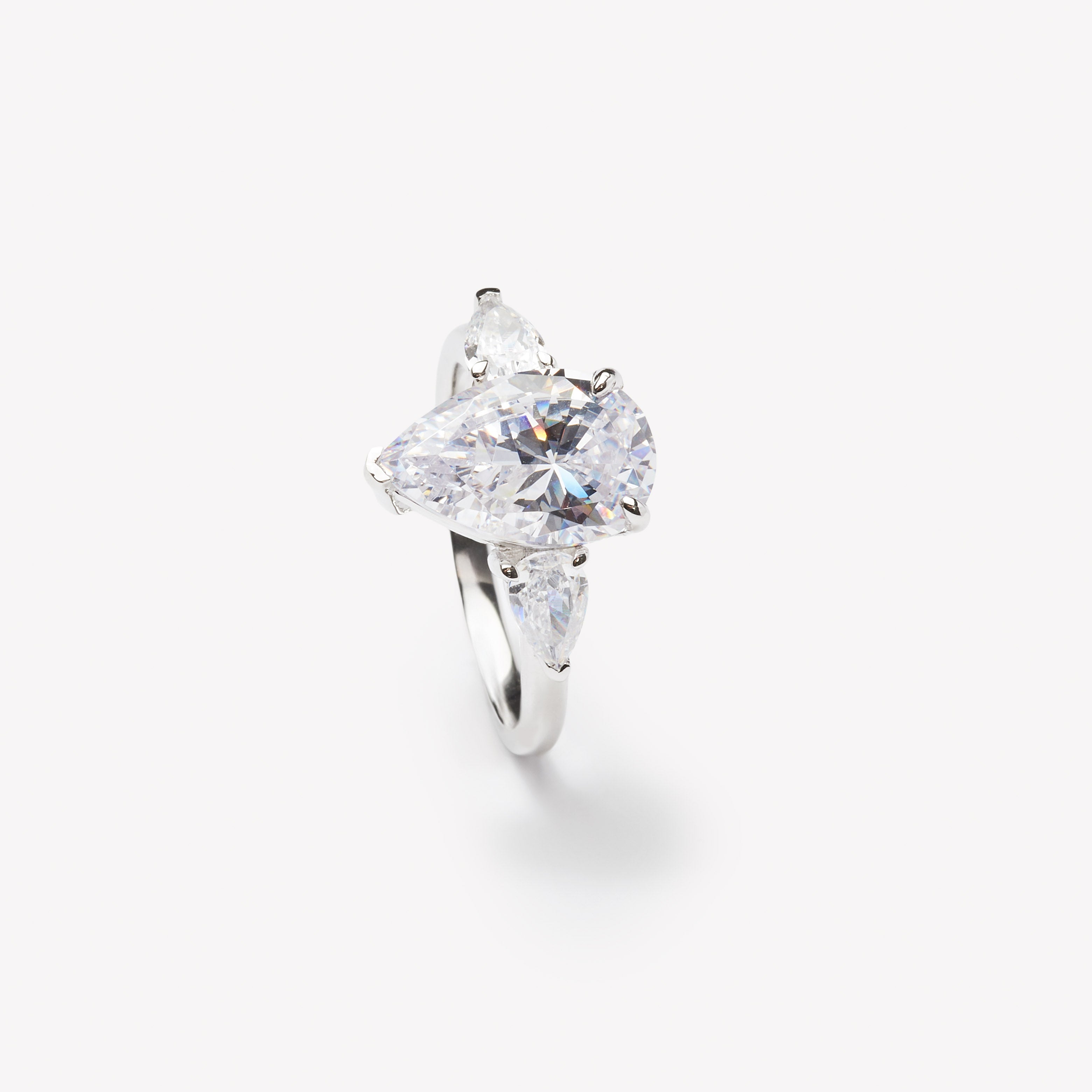 Pear cut three-stone engagement ring by IRALIS featuring lab-grown diamonds in DEF color and VS1–VS2 clarity, Zurich designed