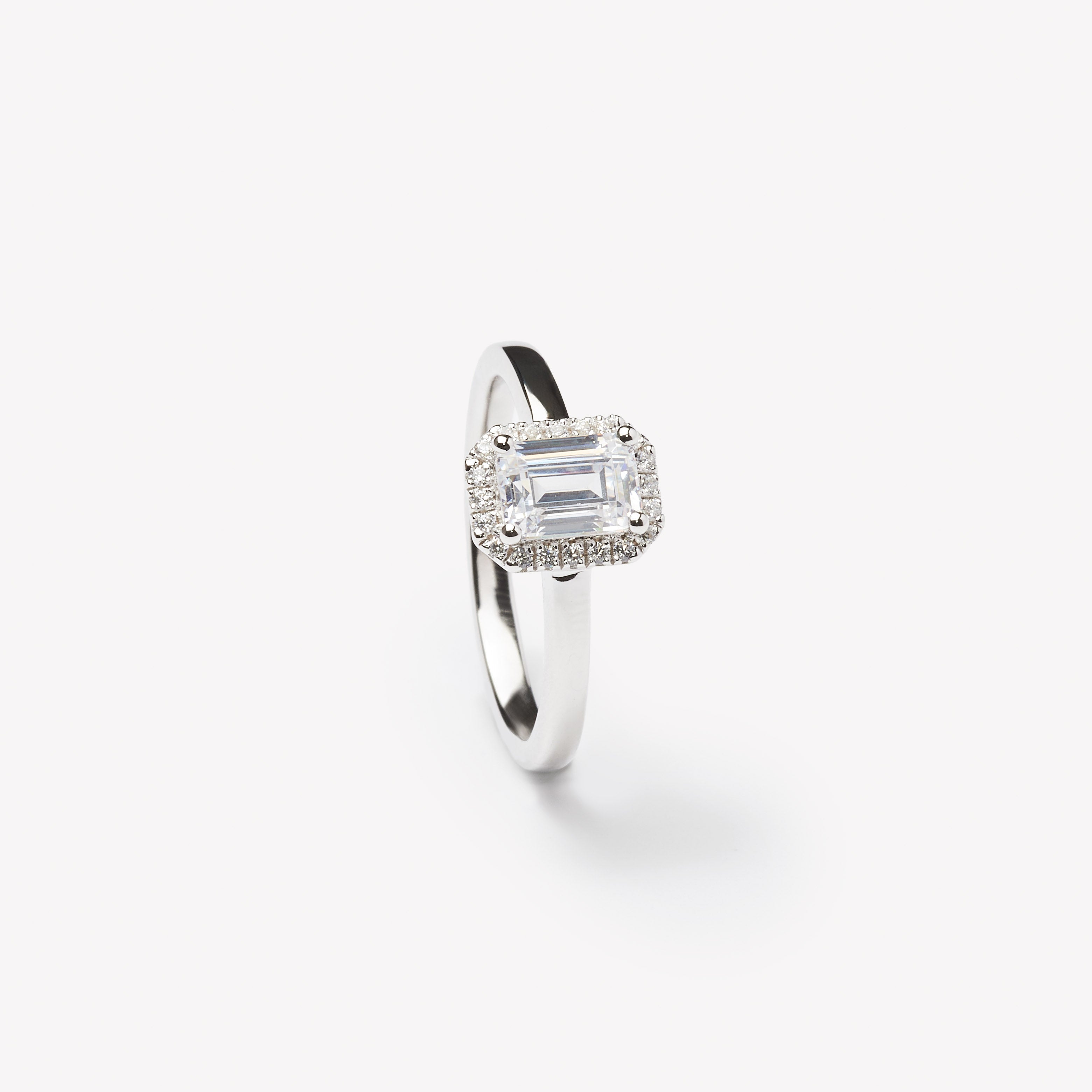 Emerald cut engagement ring with halo by IRALIS featuring lab-grown diamonds, DEF color and VS1–VS2 clarity, Zurich designed