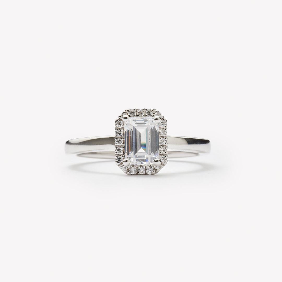 Emerald cut engagement ring with halo by IRALIS featuring lab-grown diamonds, DEF color and VS1–VS2 clarity, Zurich designed