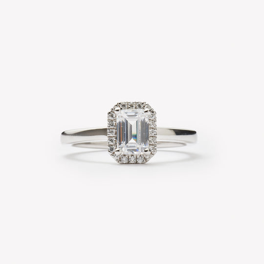 Emerald cut engagement ring with halo by IRALIS featuring lab-grown diamonds, DEF color and VS1–VS2 clarity, Zurich designed