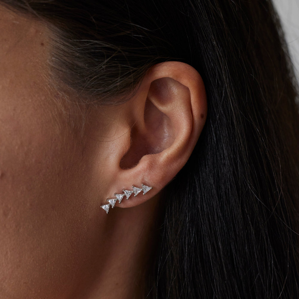 18k gold lab grown diamond studs with triangular shaped diamonds. On model.