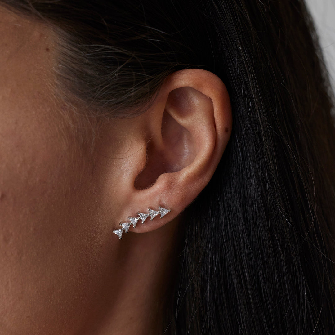 18k gold lab grown diamond studs with triangular shaped diamonds. On model.