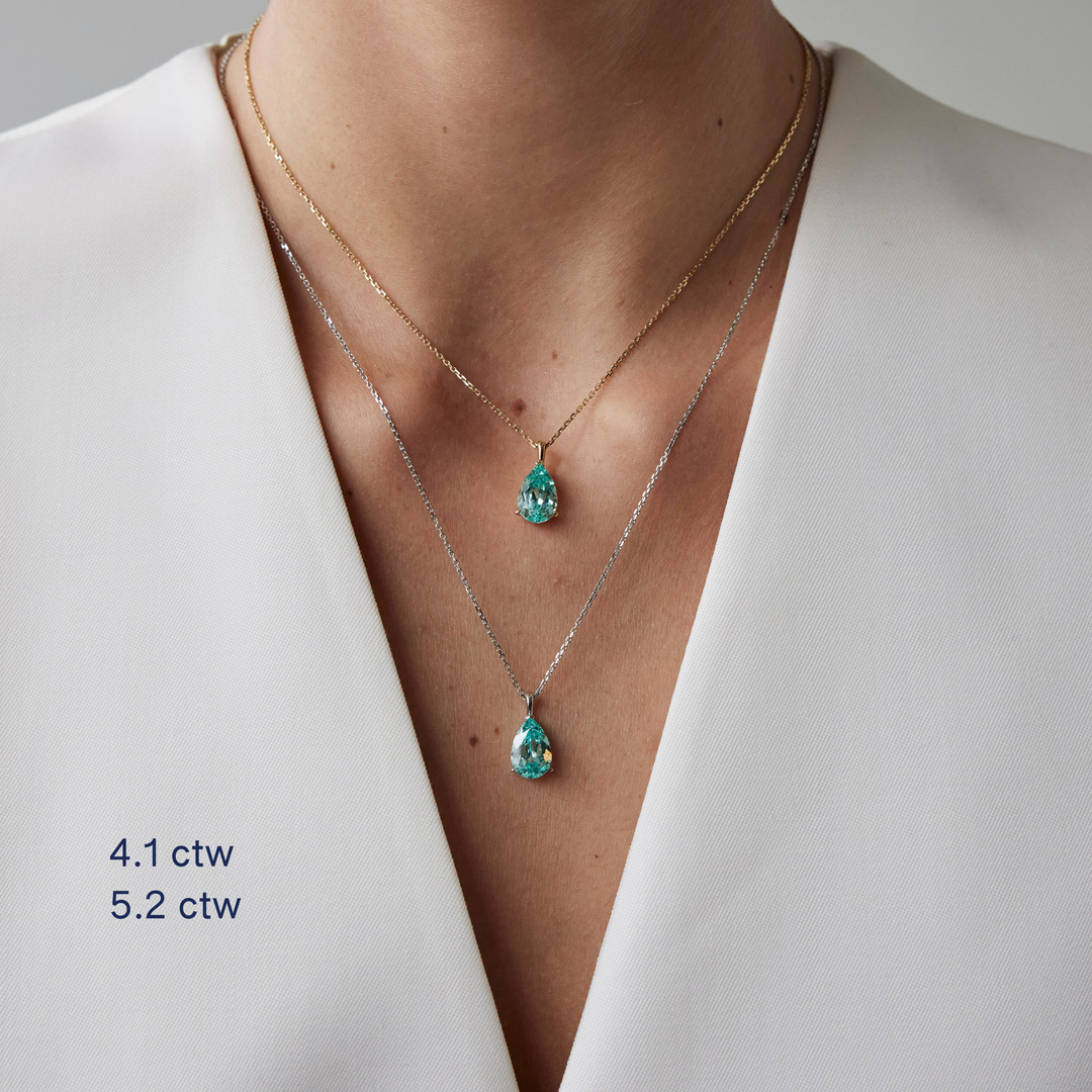 Pear cut necklace by IRALIS featuring lab-grown Paraiba stones in vibrant turquoise, Zurich designed and custom made on model