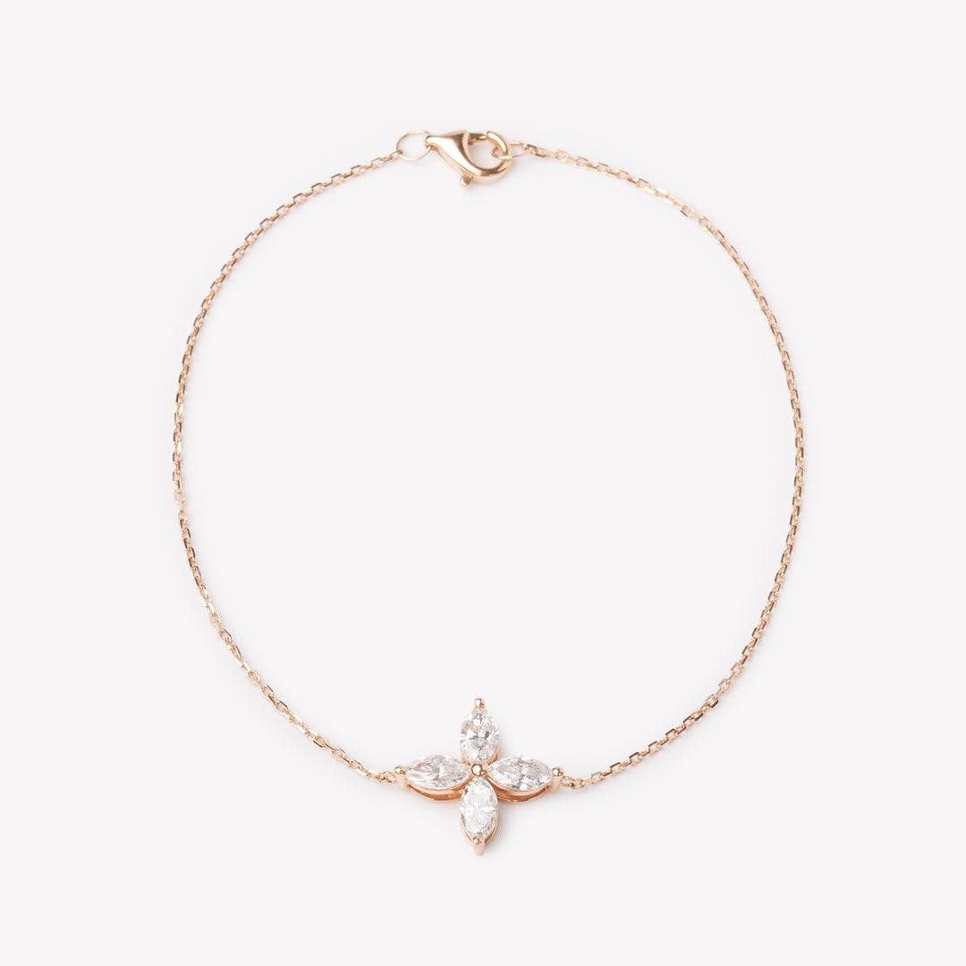 18k rose gold bracelet with a floral lab grown diamond. Four marquise cut diamonds.