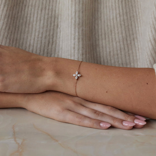 18k rose gold bracelet with a floral lab grown diamond. Four marquise cut diamonds. On model.
