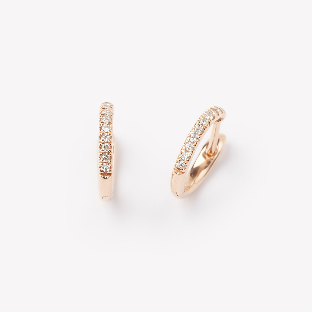 Pair of 18k gold hoop earrings with small lab grown diamonds. 0.1 carats of diamonds