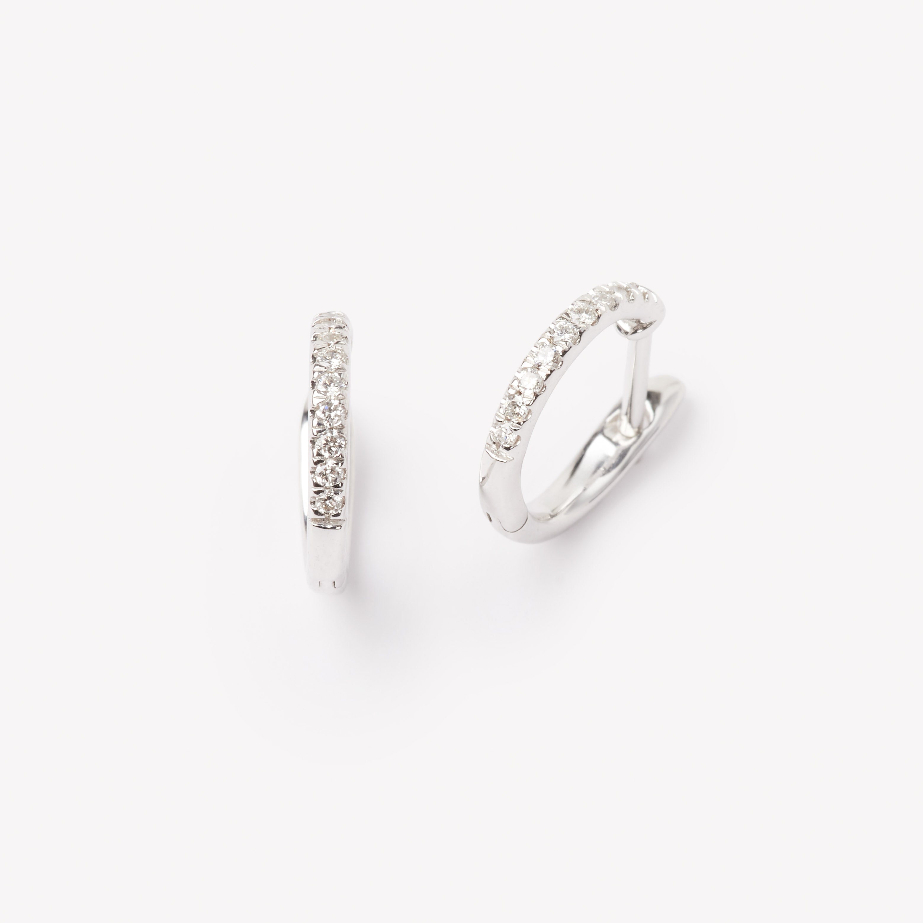 Pair of 18k gold hoop earrings with small lab grown diamonds. 0.1 carats of diamonds