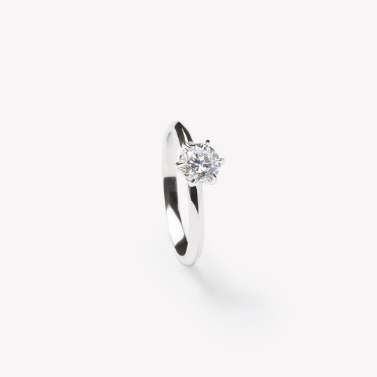 Round brilliant cut engagement ring by IRALIS with lab-grown diamonds in DEF color, VS1–VS2 clarity, knife setting, Zurich designed