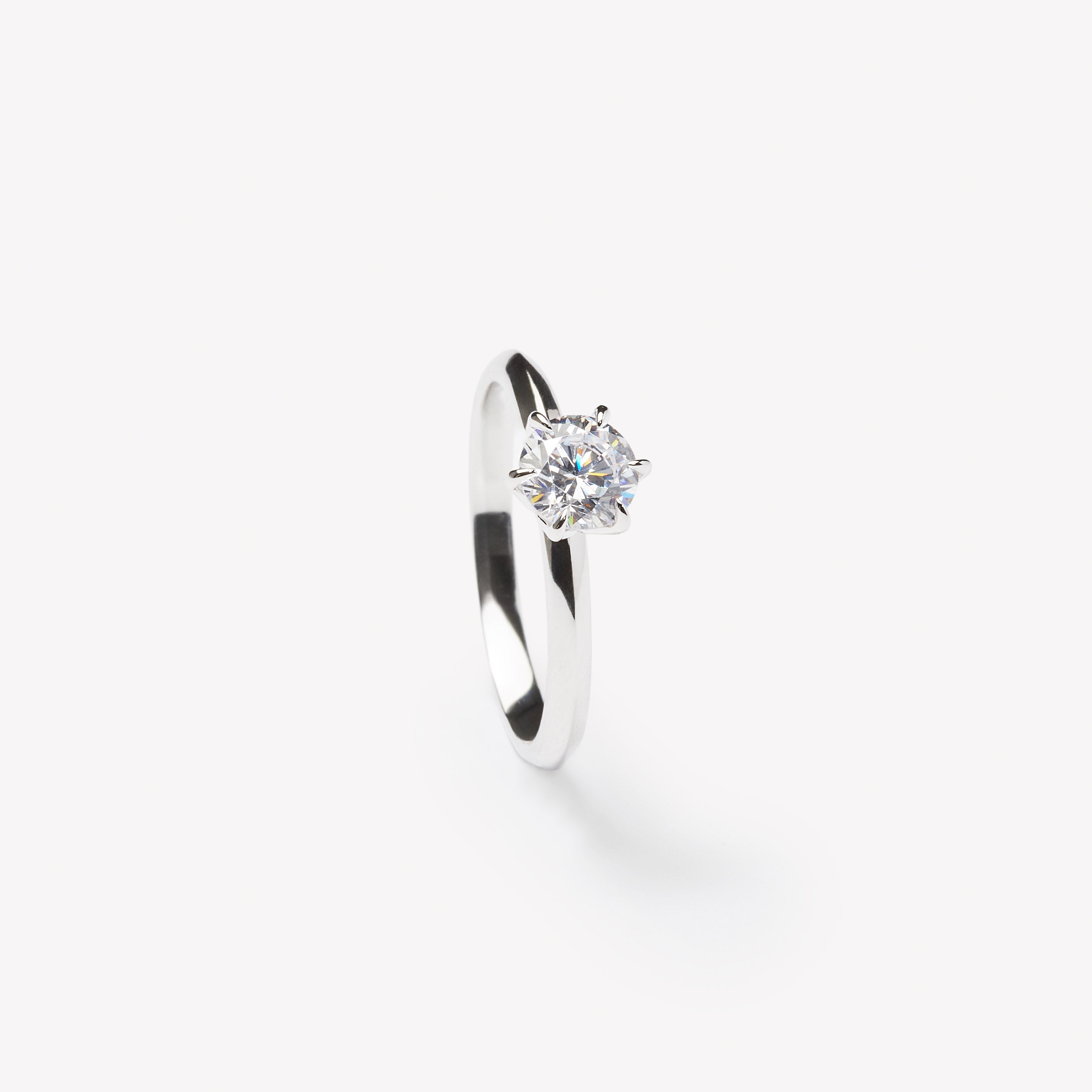 Round brilliant cut engagement ring by IRALIS with lab-grown diamonds in DEF color, VS1–VS2 clarity, knife setting, Zurich designed