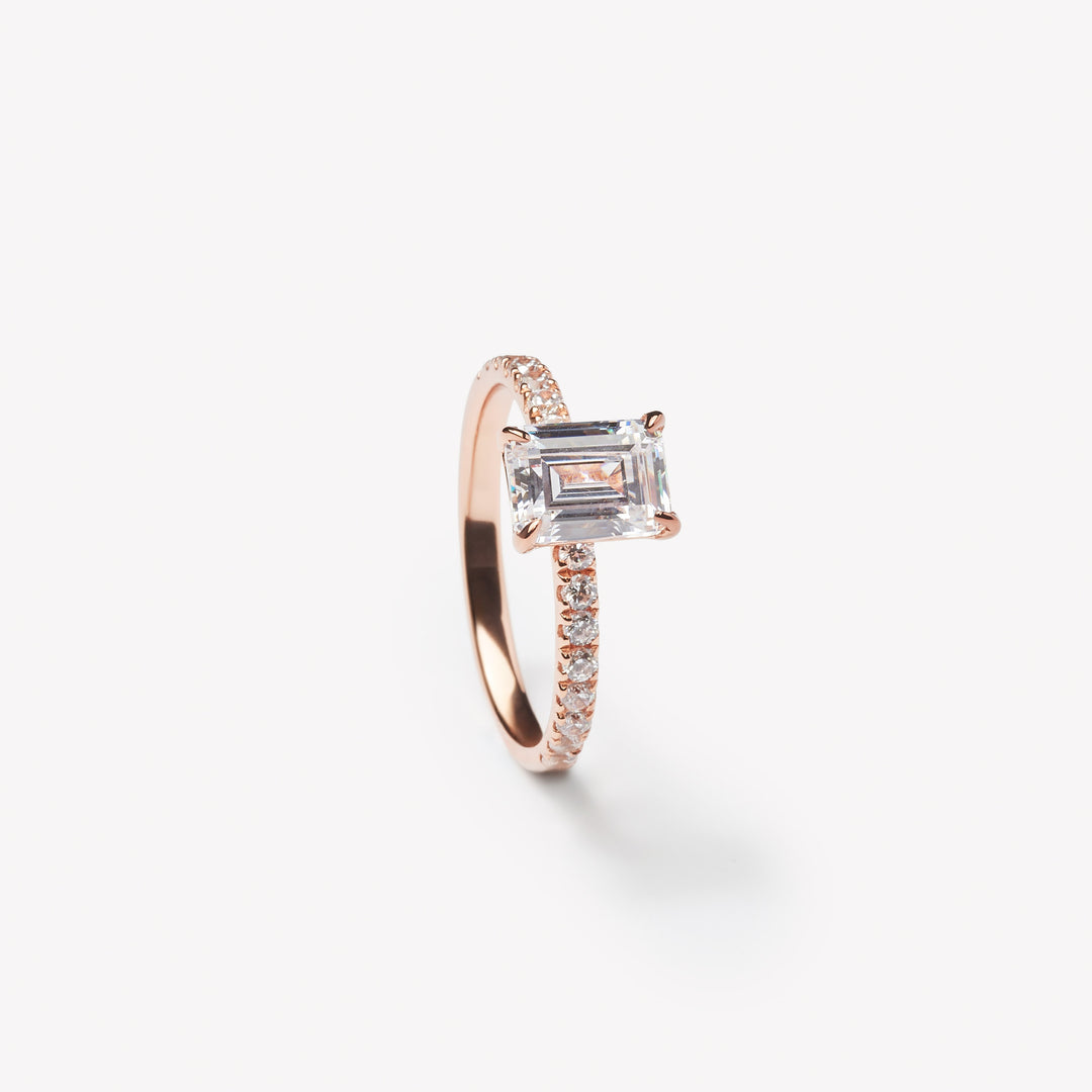 Emerald cut engagement ring by IRALIS with pave setting and lab-grown diamonds in DEF color, VS1–VS2 clarity, Zurich designed
