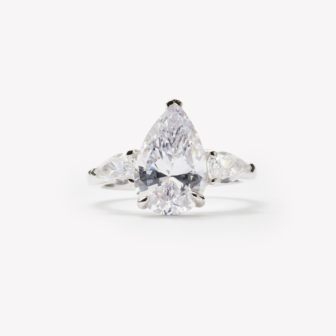 Pear cut three-stone engagement ring by IRALIS featuring lab-grown diamonds in DEF color and VS1–VS2 clarity, Zurich designed
