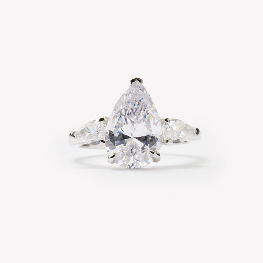 Pear cut three-stone engagement ring by IRALIS featuring lab-grown diamonds in DEF color and VS1–VS2 clarity, Zurich designed