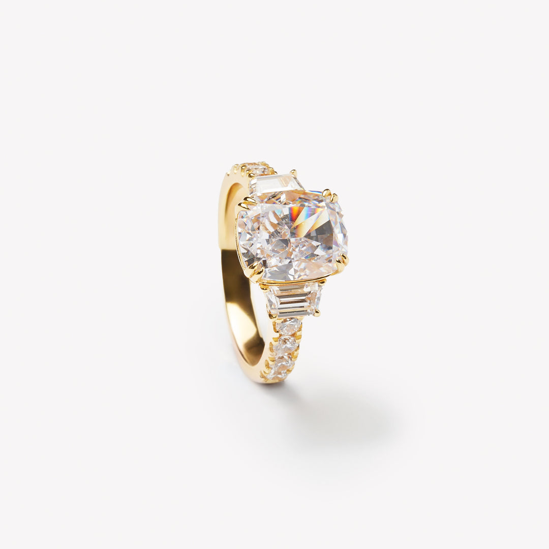 Elongated cushion cut three-stone ring by IRALIS with pavé setting, lab-grown diamonds, DEF color and VS1–VS2 clarity, Zurich designed