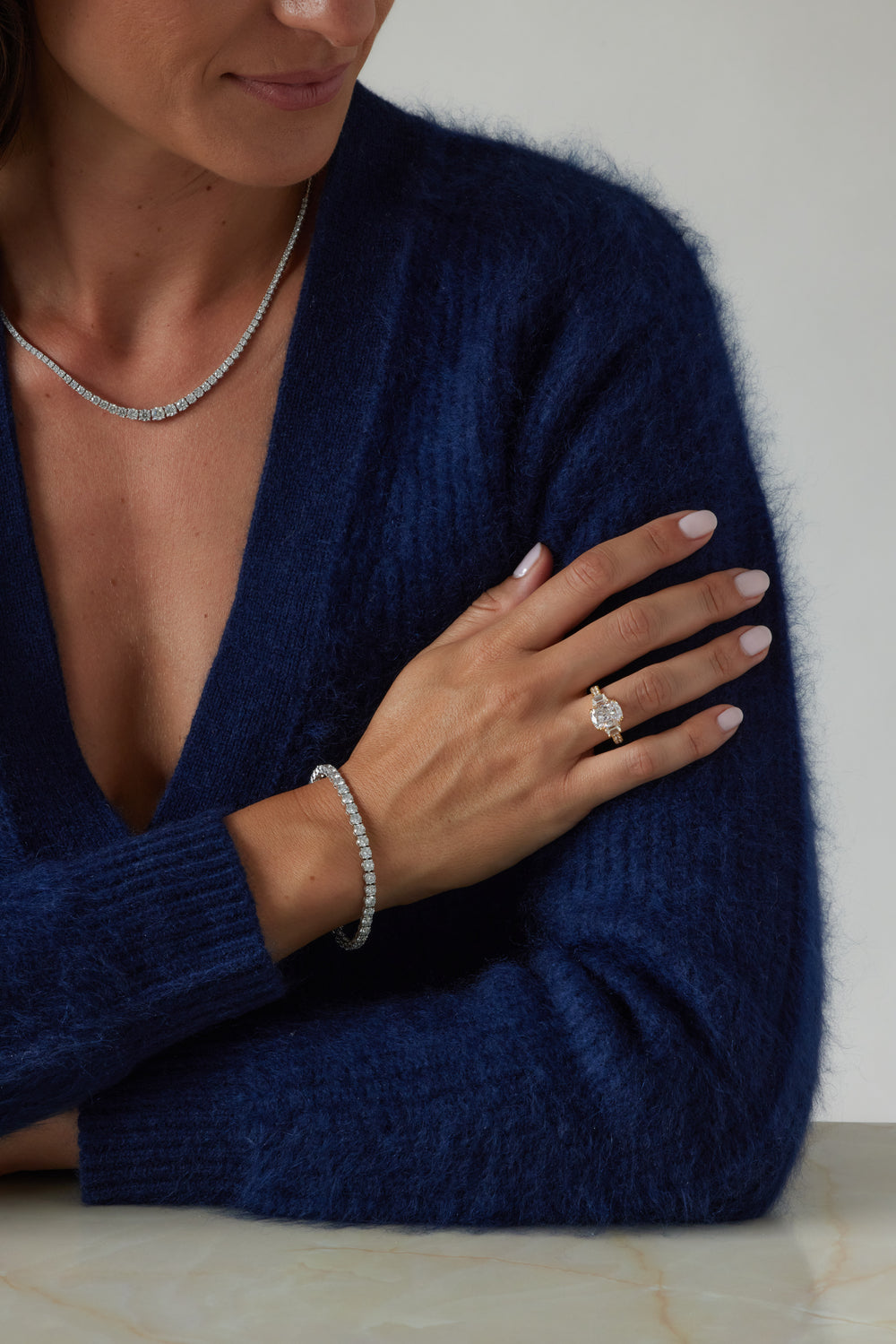 Elongated cushion cut three-stone ring by IRALIS with pavé setting, lab-grown diamonds, DEF color and VS1–VS2 clarity, Zurich designed