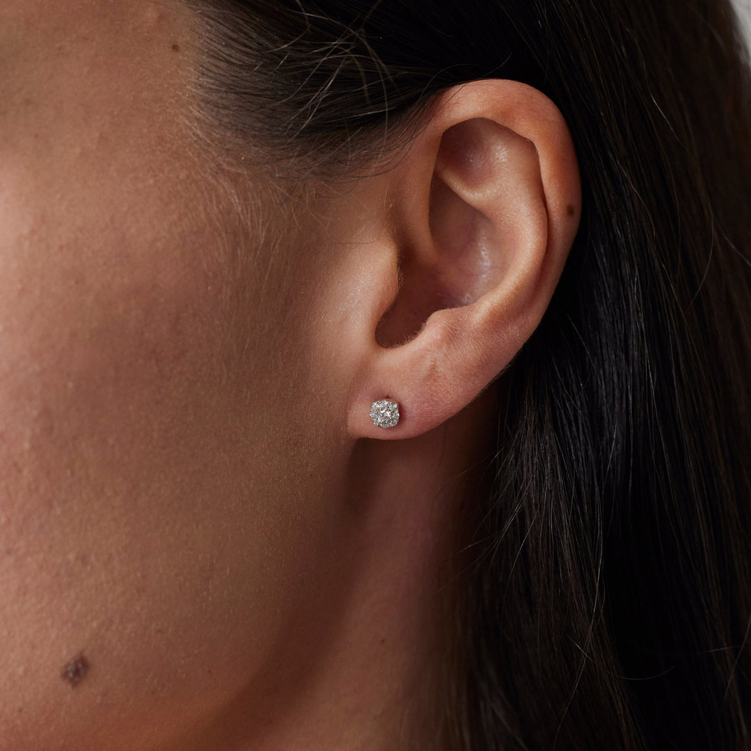 18k gold la grown diamond studs with round brilliant diamonds. Designed in Zurich. On Model.