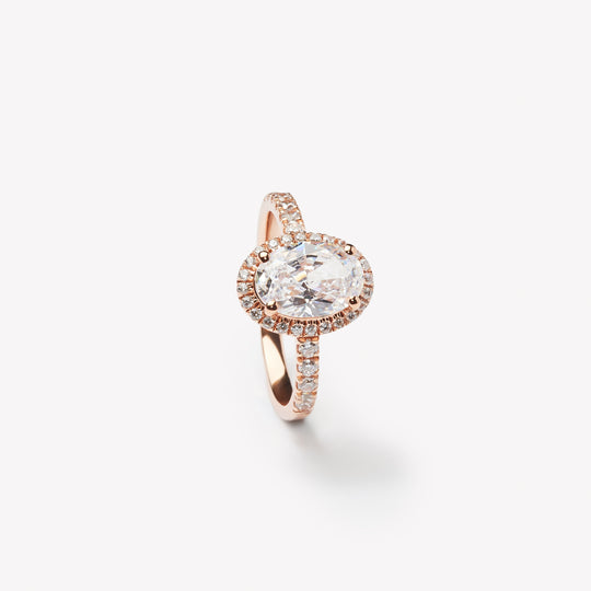 Elegant oval cut engagement ring with halo by IRALIS – Zurich-designed fine jewelry with pave setting and VS1–VS2 clarity.
