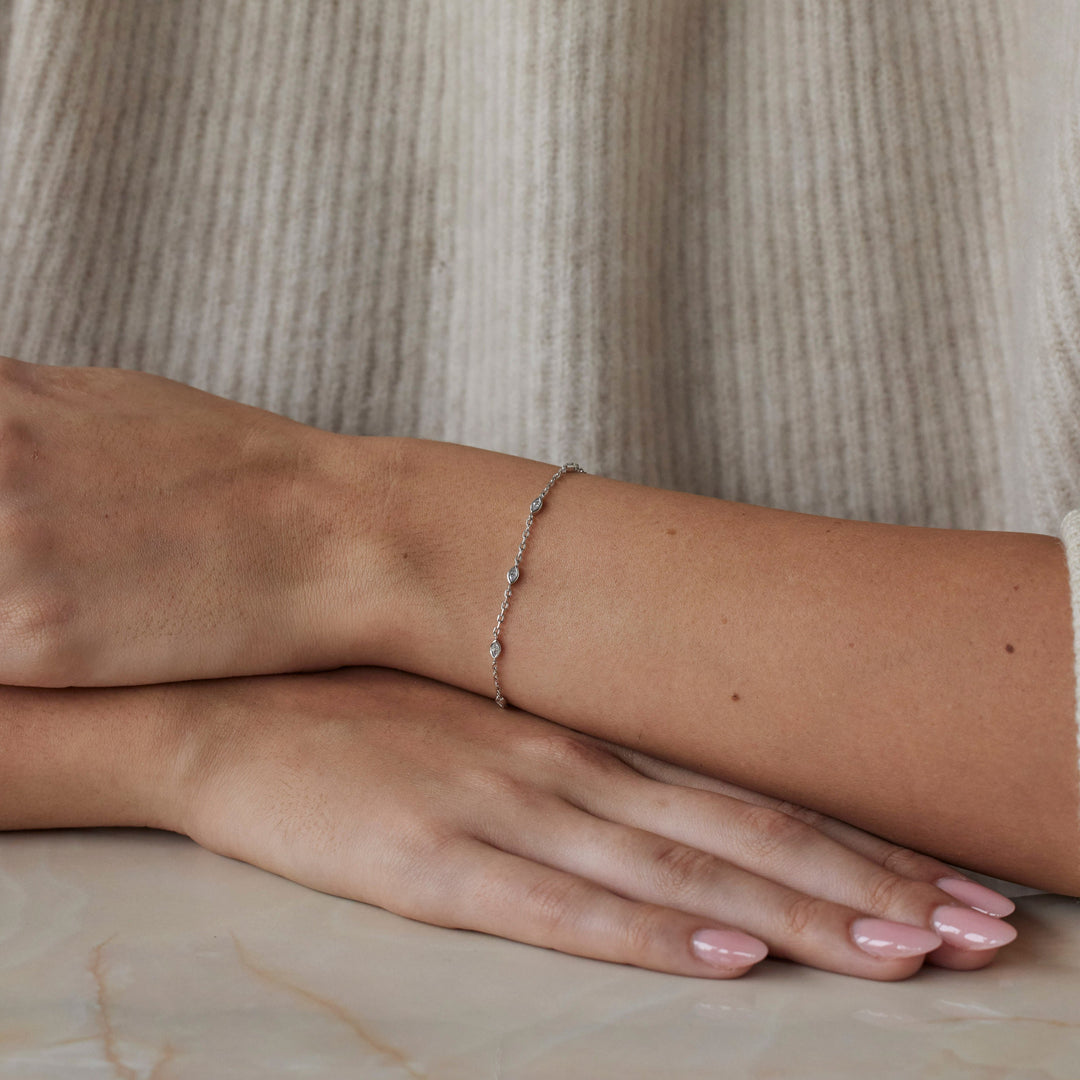 18k white gold bracelet with multiple marquise cut diamonds. Adjustable to different lengths. On model.