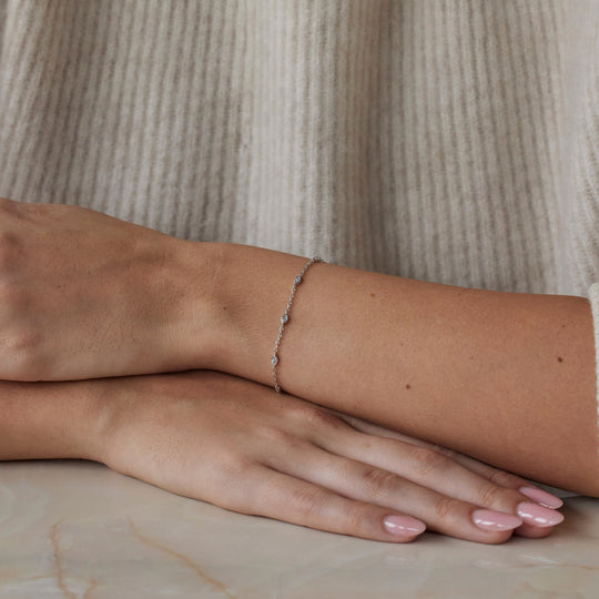 18k white gold bracelet with multiple marquise cut diamonds. Adjustable to different lengths. On model.