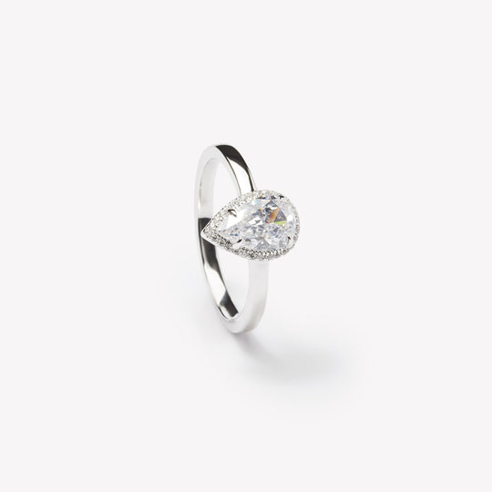 Pear cut engagement ring with halo by IRALIS – Zurich-designed fine jewelry with DEF color and VS1–VS2 clarity.