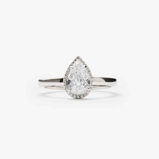 Pear cut engagement ring with halo by IRALIS – Zurich-designed fine jewelry with DEF color and VS1–VS2 clarity.