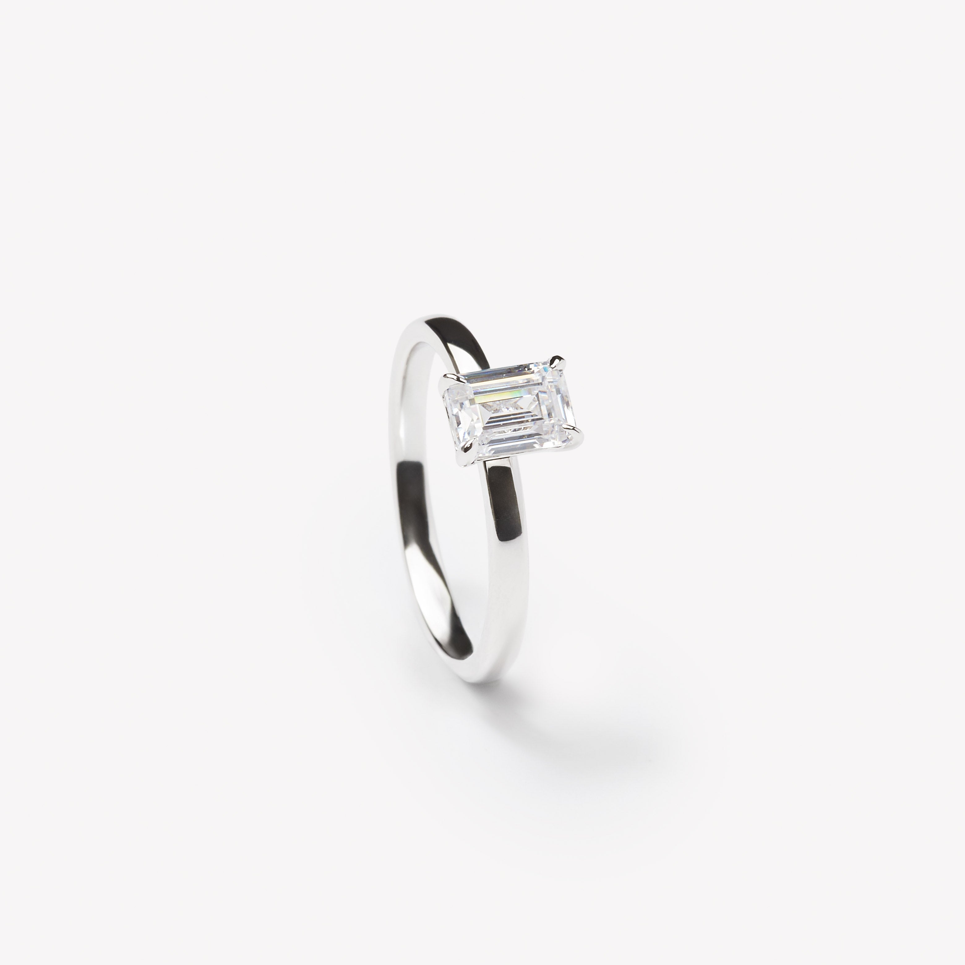 Emerald cut engagement ring by IRALIS featuring lab-grown diamonds in DEF color and VS1–VS2 clarity, Zurich designed
