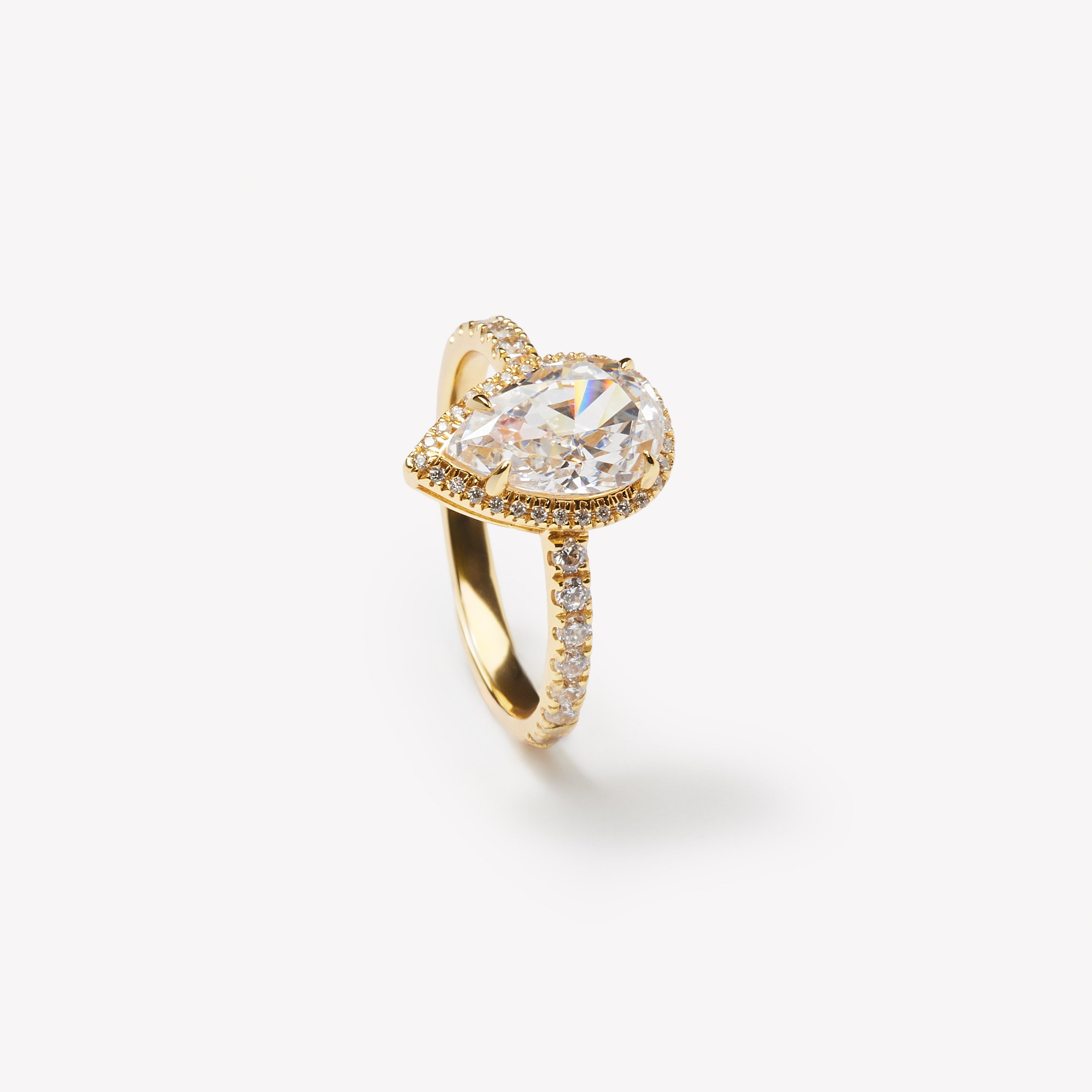 Pear cut engagement ring with halo by IRALIS – Zurich-designed fine jewelry with pave ring setting and VS1–VS2 clarity.