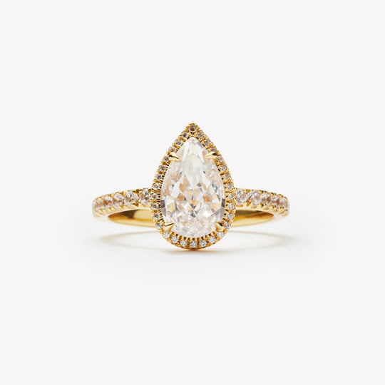 Pear cut engagement ring with halo by IRALIS – Zurich-designed fine jewelry with pave ring setting and VS1–VS2 clarity.