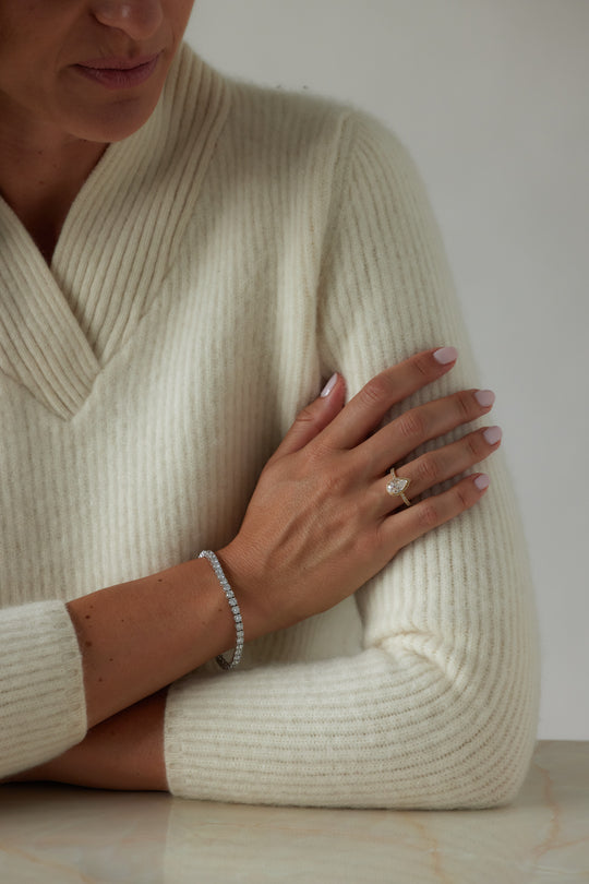 Pear cut engagement ring with halo by IRALIS – Zurich-designed fine jewelry with pave ring setting and VS1–VS2 clarity.