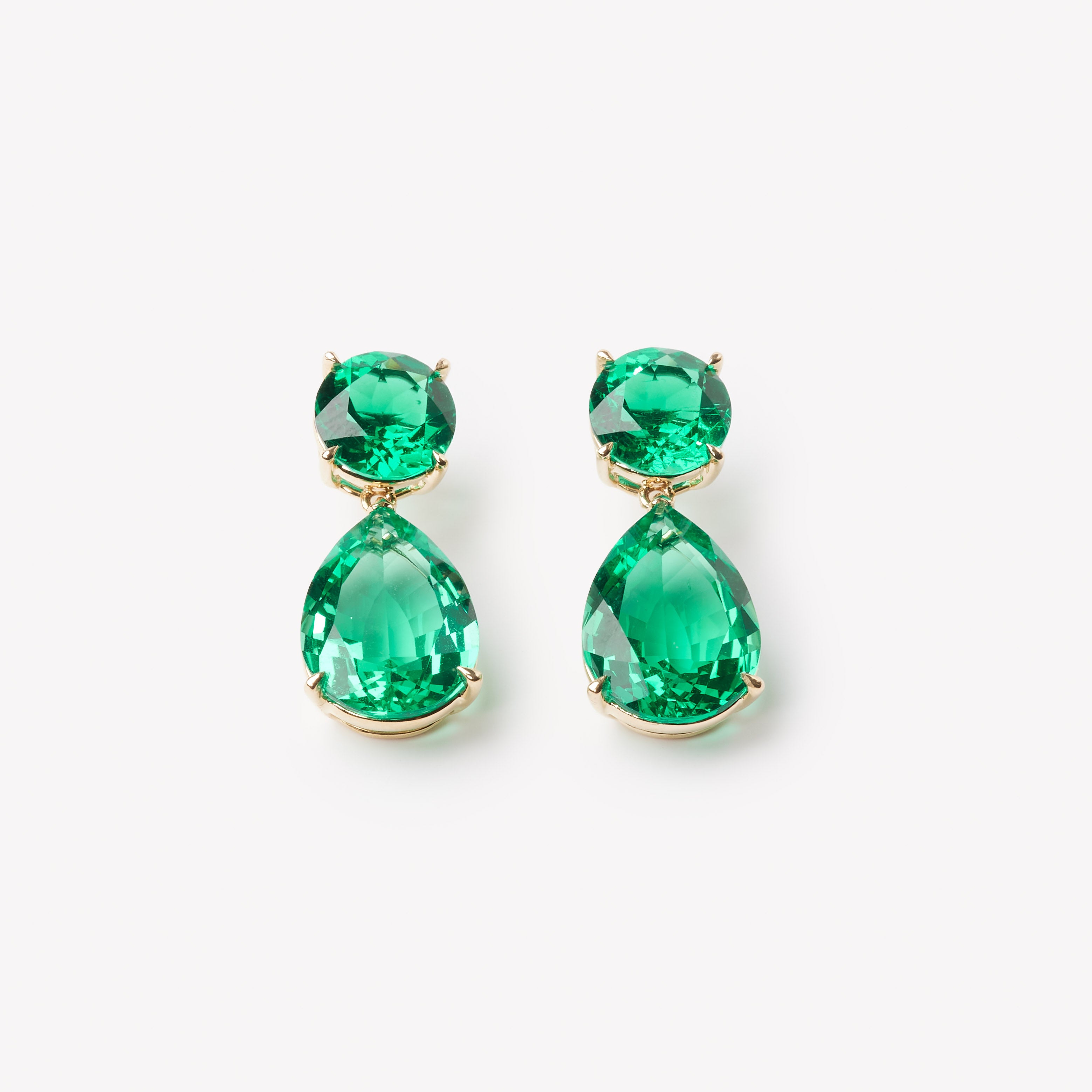 18k gold lab grown emerald earrings. pear and round brilliant cut emeralds. Designed in Zurich.