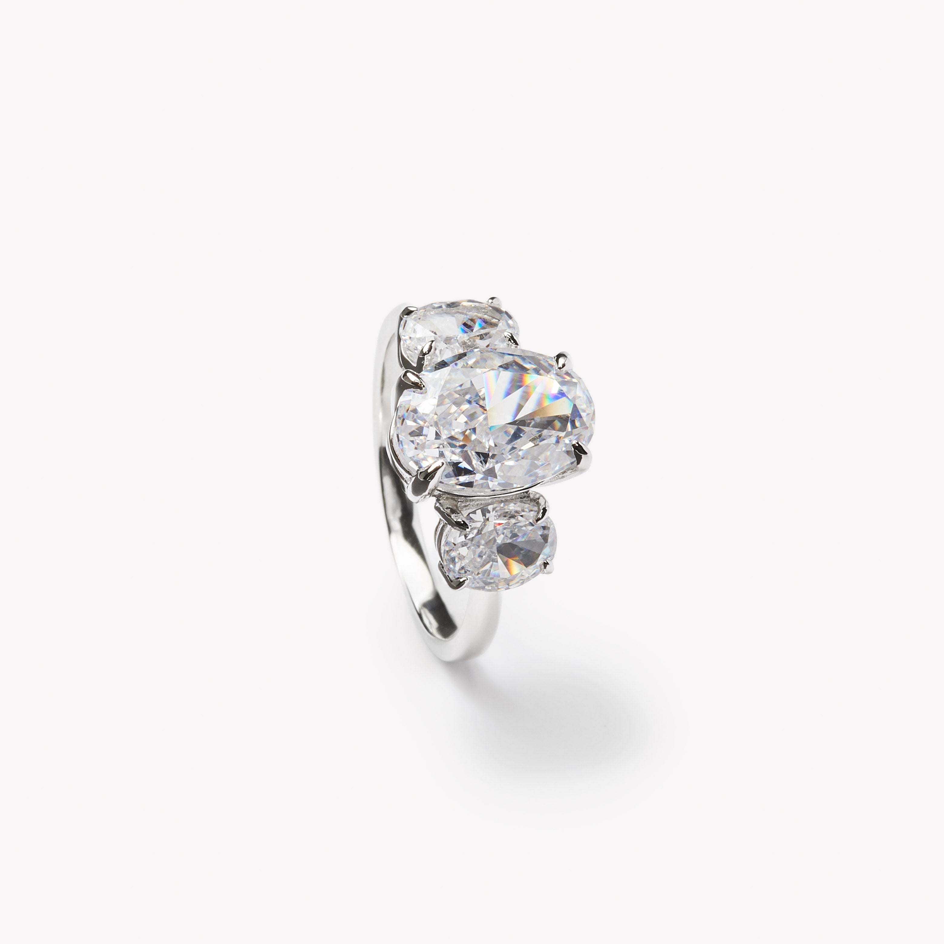 Oval cut three-stone engagement ring by IRALIS featuring lab-grown diamonds in DEF color and VS1–VS2 clarity, Zurich designed