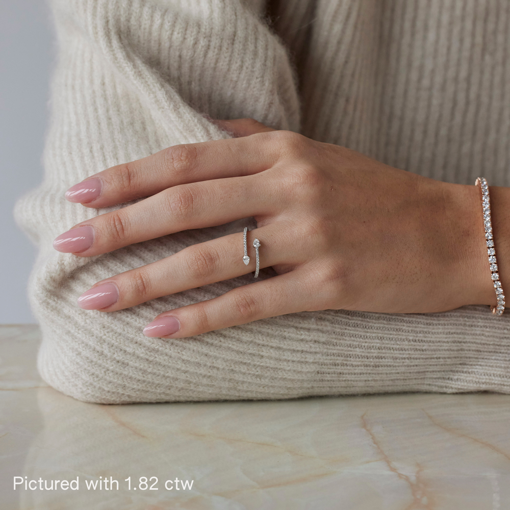 Round brilliant ring with pear-cut side stones by IRALIS featuring lab-grown diamonds in DEF color and VS1–VS2 clarity, Zurich designed