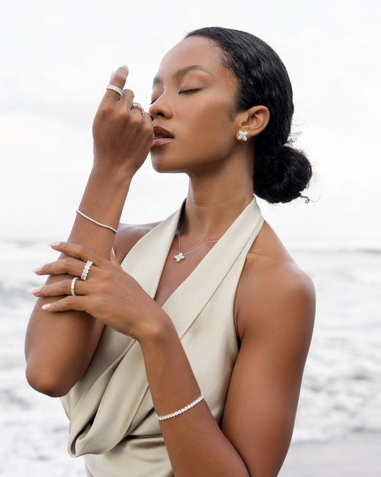 18k white gold lab grown diamond studs. Four marquise cut diamonds embedded in round brilliant cut diamonds. On model.