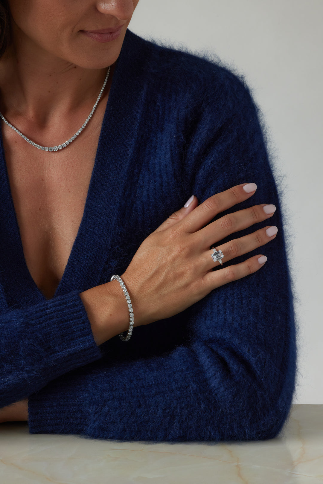 Emerald cut three-stone engagement ring by IRALIS – Zurich-designed fine jewelry with DEF color and VS1–VS2 clarity.