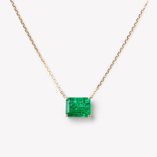Emerald cut necklace by IRALIS featuring lab-grown emeralds in 14k gold, designed in Zurich 