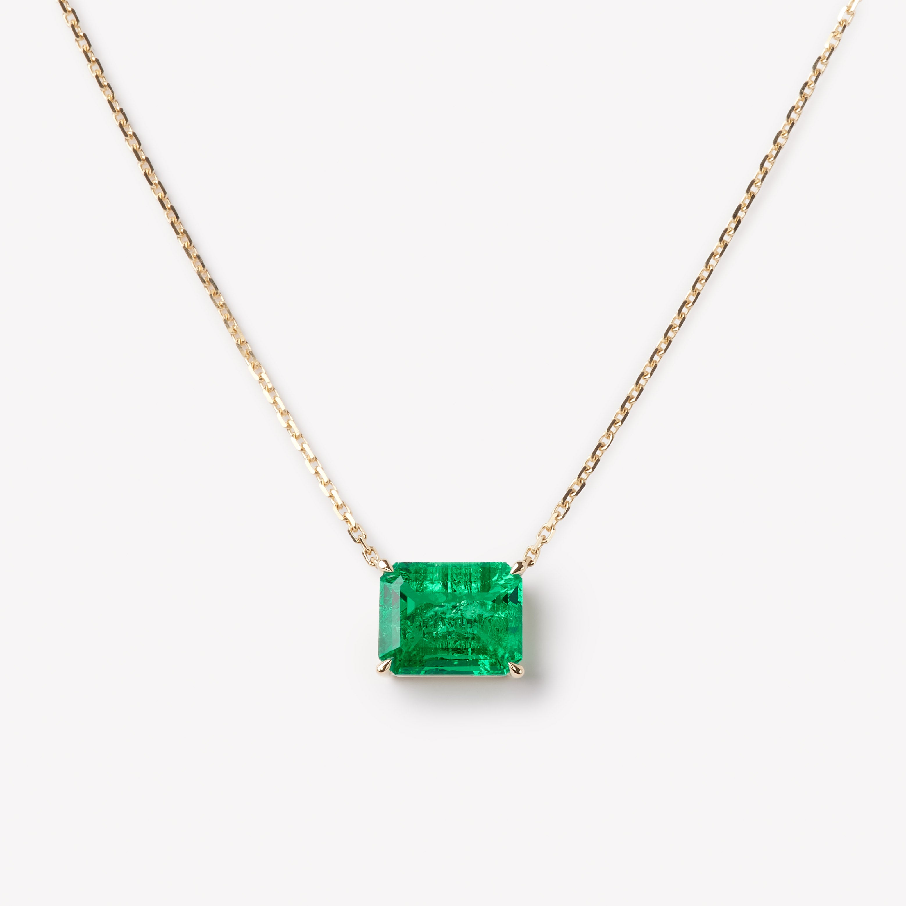 Emerald cut necklace by IRALIS featuring lab-grown emeralds in 14k gold, designed in Zurich 