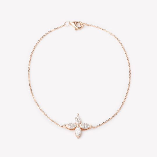 18k rose gold bracelet with a floral lab grown diamond. Four marquise cut diamonds.