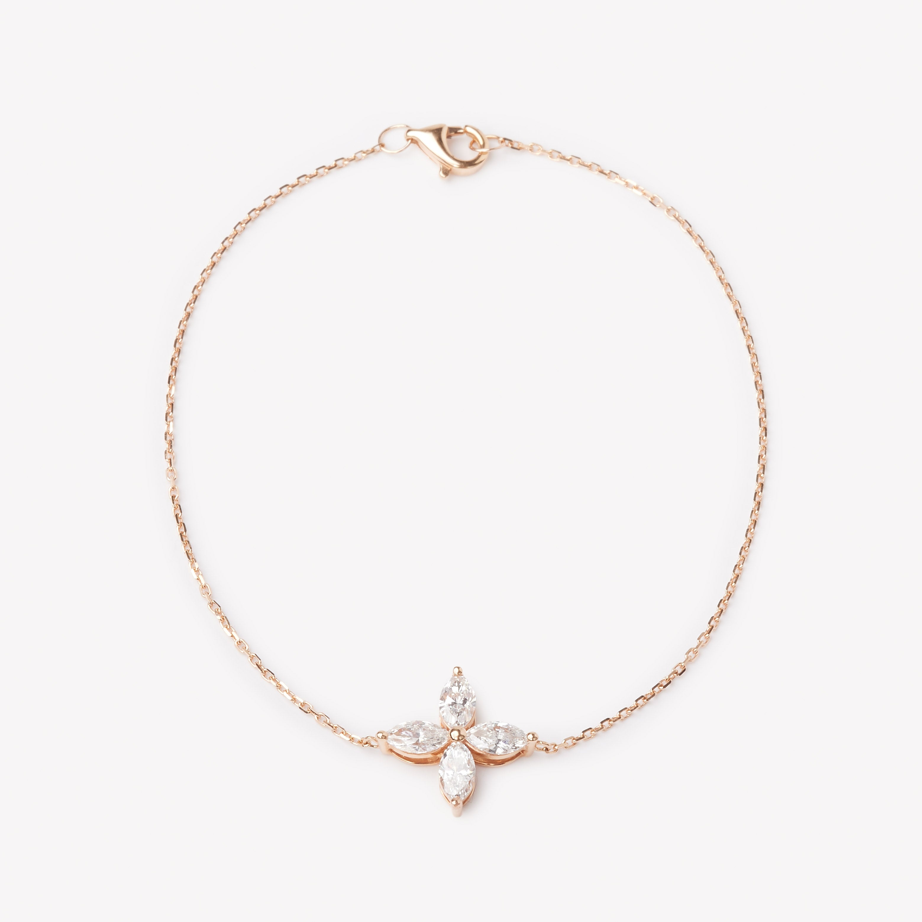 18k rose gold bracelet with a floral lab grown diamond. Four marquise cut diamonds.