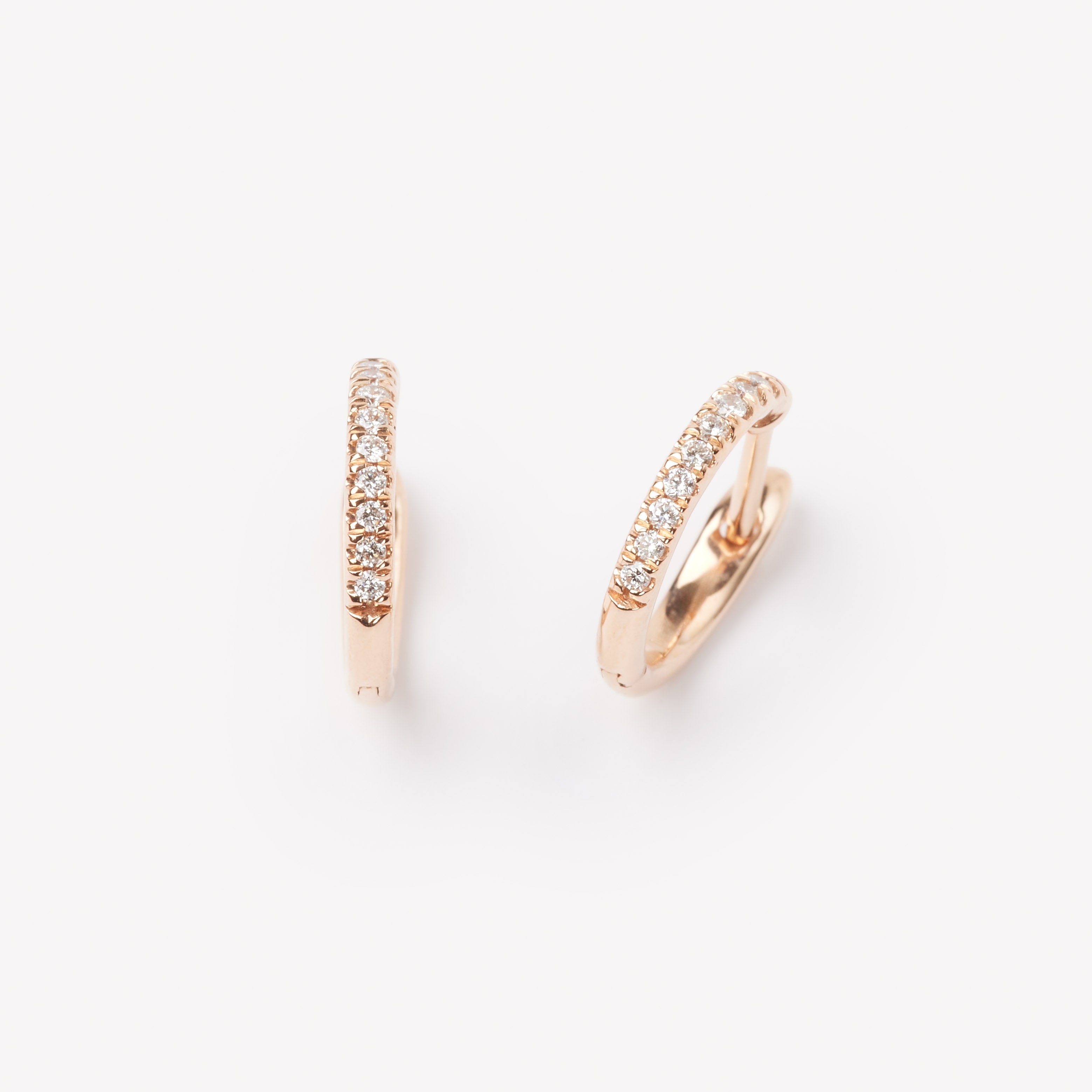 Pair of 18k gold hoop earrings with small lab grown diamonds. 0.1 carats of diamonds
