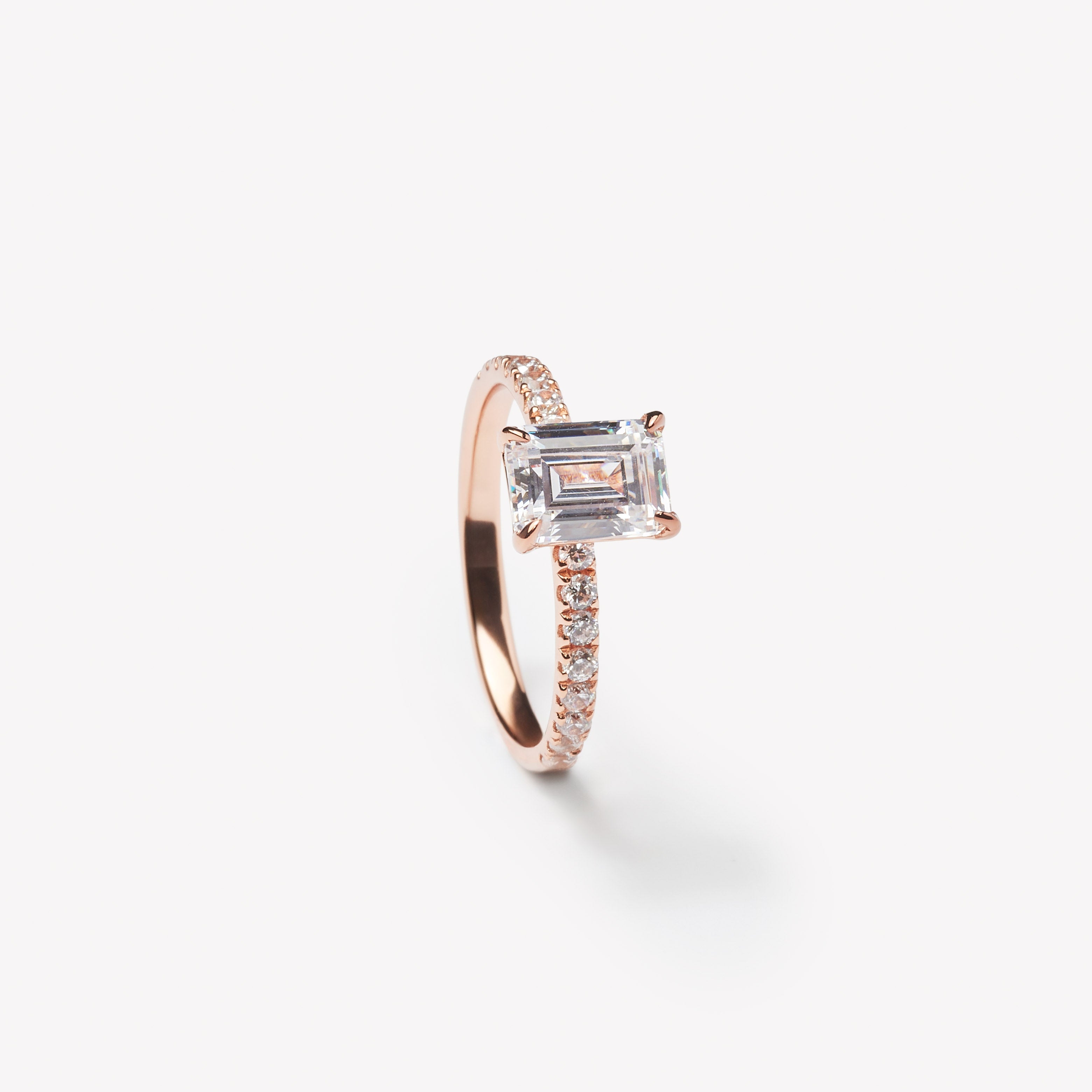 Emerald cut engagement ring by IRALIS with pave setting and lab-grown diamonds in DEF color, VS1–VS2 clarity, Zurich designed