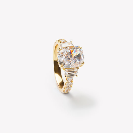 Elongated cushion cut three-stone ring by IRALIS with pavé setting, lab-grown diamonds, DEF color and VS1–VS2 clarity, Zurich designed