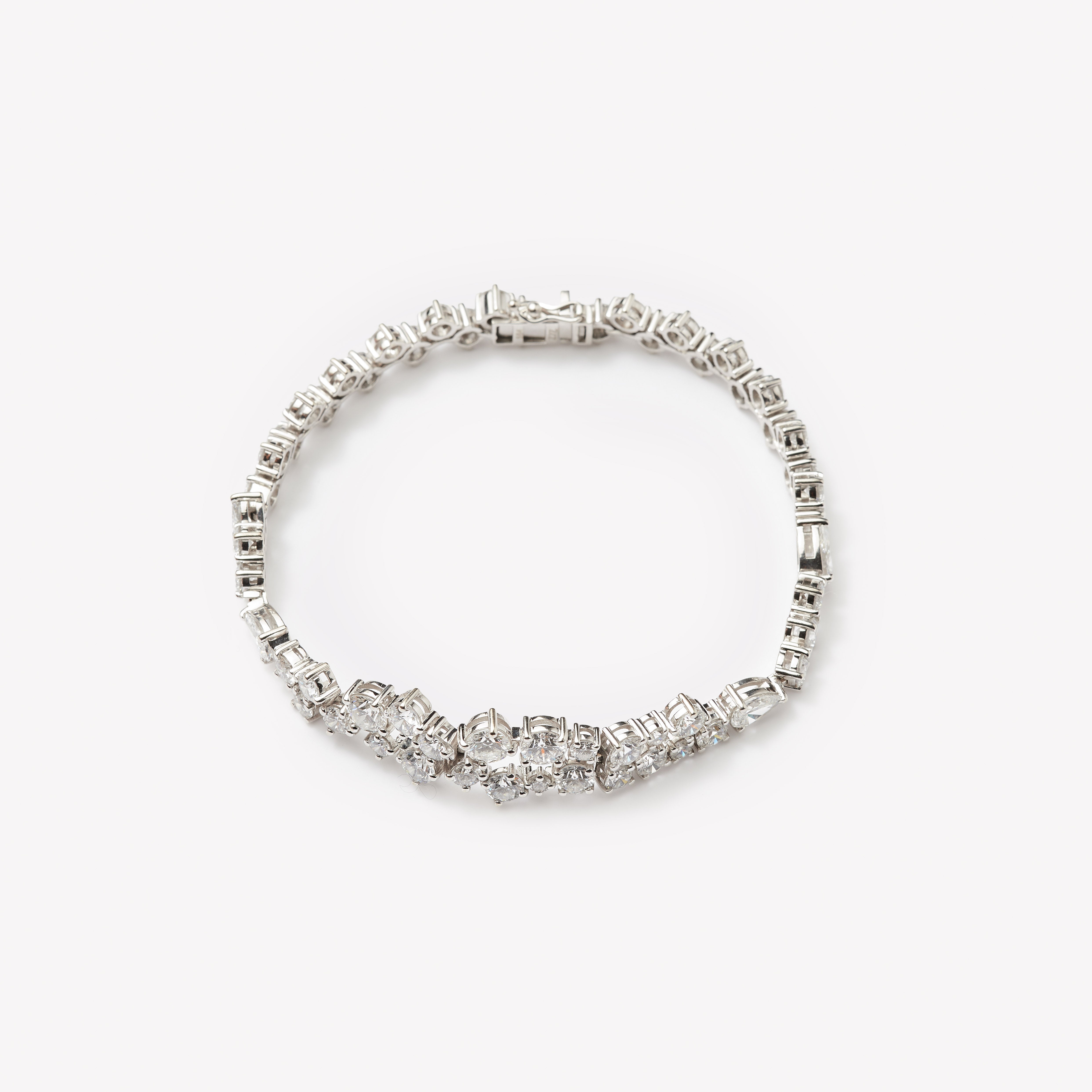 18k white gold bracelet with lab grown diamonds in round and pear cut. Designed in Zurich.