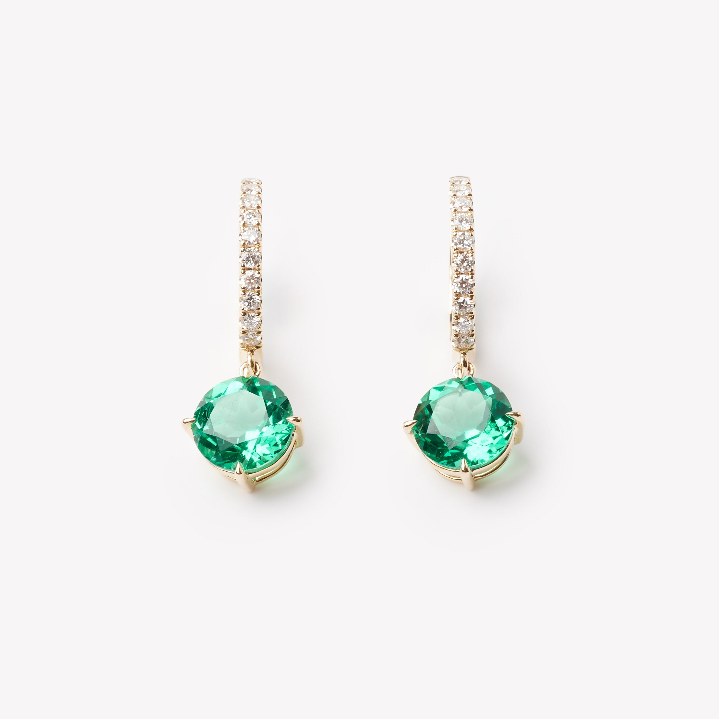 18k gold lab grown diamond and emerald earrings. Round brilliant emerald and diamond-adorned loop. 