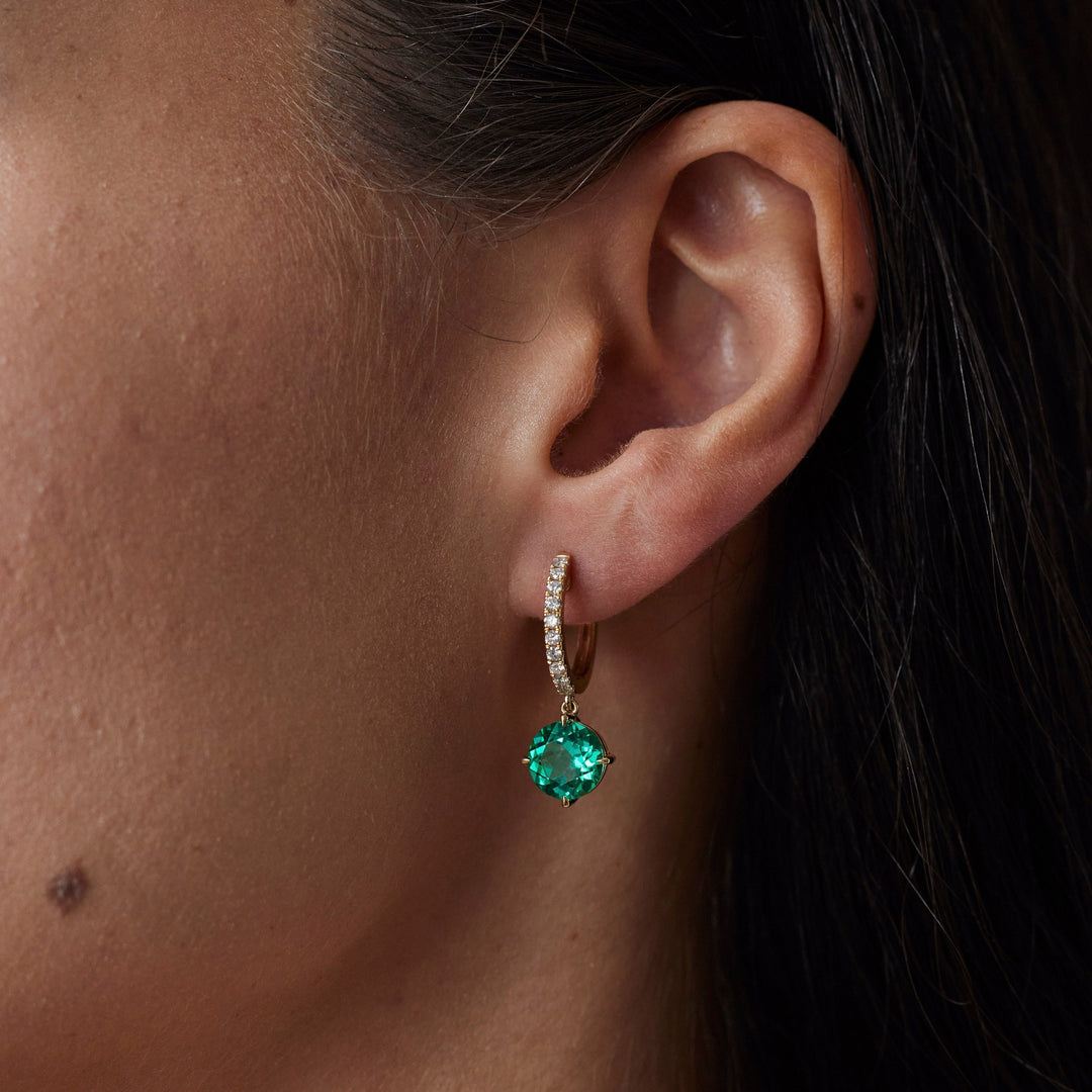 18k gold lab grown diamond and emerald earrings. Round brilliant emerald and diamond-adorned loop. 