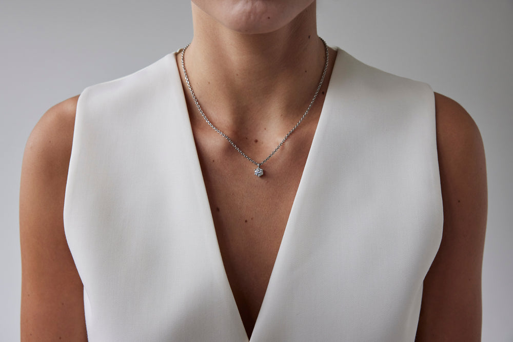 Round brilliant cut necklace by IRALIS featuring lab-grown DEF color diamonds on 18k anker chain, Zurich designed on model