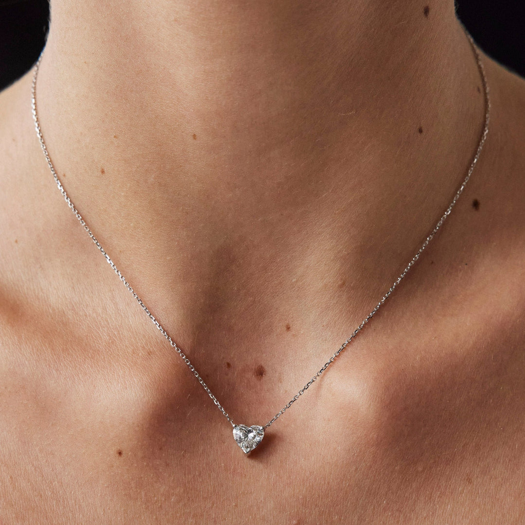 Heart cut necklace by IRALIS featuring lab-grown DEF color diamonds in 18k gold, Zurich designed on model