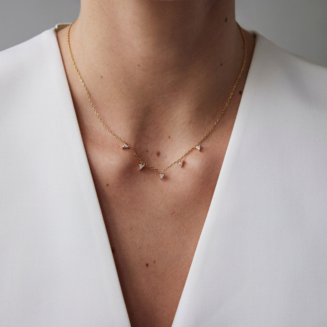 Round brilliant cut necklace by IRALIS featuring lab-grown DEF color diamonds in 18k gold, Zurich designed on model